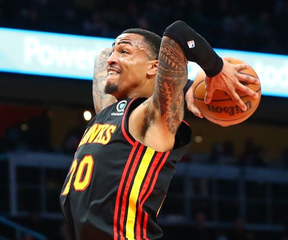 Hawks forward John Collins soars to the basket for a slam against the Indiana Pacers during the first period in a NBA basketball game on Tuesday, Feb. 8, 2022, in Atlanta.  “Curtis Compton / Curtis.Compton@ajc.com”`