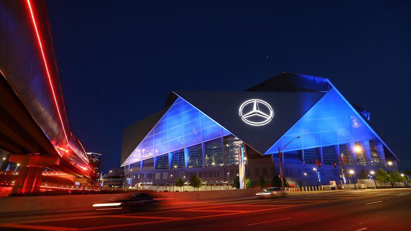 Mercedes-Benz Stadium transforms into a beacon of blue as part of an initiative to salute essential workers on the frontlines of the coronavirus pandemic on Thursday, April 9, 2020, in Atlanta.