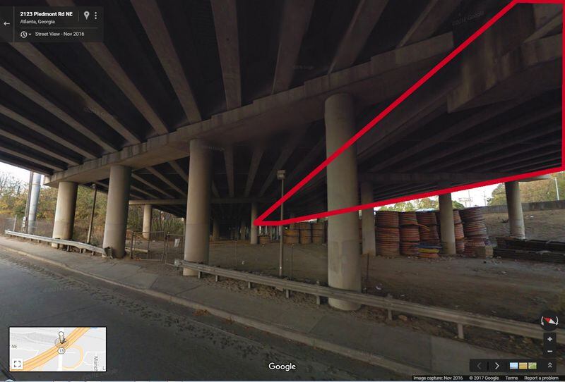 NOVEMBER 2016: This image from Google Maps Street View shows the underneath of I-85 where the interstate passes over Piedmont Road, looking to the northeast. The area marked in red is the northbound lanes. The section that collapsed is above the stacked coils of material seen at right. (Google Maps Street View)