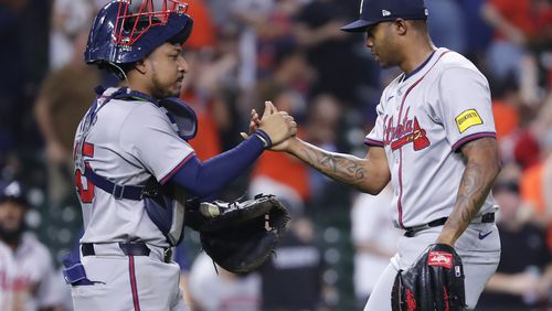 Braves catcher Chadwick Tromp and closer Raisel Iglesias celebrate after Tuesday's 6-2 win over the Astros in Houston. (AP Photo/Michael Wyke)