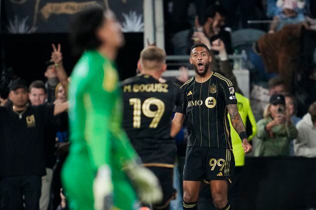 Los Angeles FC forward Denis Bouanga (99) and midfielder Mateusz Bogusz (19) celebrate after a goal during the second half of an MLS soccer match against the Vancouver Whitecaps in Los Angeles, Saturday, May 11, 2024. (AP Photo/Ashley Landis)