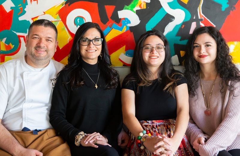Chef Julio Delgado with his family, from left, wife Zoribeth and daughters Juliebeth, 27, and Nathalie, 18. (RYAN FLEISHER FOR THE ATLANTA JOURNAL-CONSITUTION)