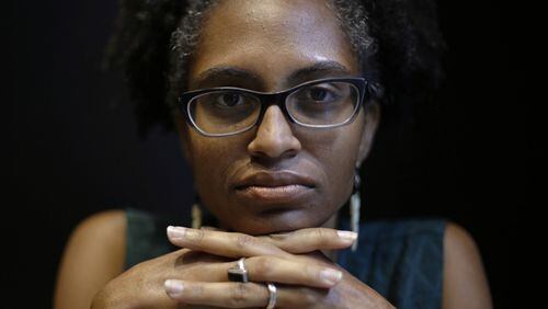 In this Sept. 7, 2018 photo, Adrienne Alexander poses for a photo in downtown Chicago. Alexander, a former Atlantan, is among countless members of the Catholic laity in the U.S. who are raising their voices in prayer and protest to demand change amid new revelations of sex abuse by priests and allegations of widespread cover-ups. Alexander organized a prayer vigil in Chicago, and became a catalyst for similar laity-led vigils in Boston, Philadelphia and other cities nationwide. (AP Photo/Kiichiro Sato)