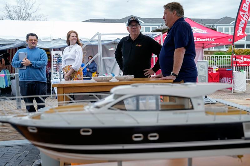 Former Maryland Gov. Larry Hogan, second from right, talks with Bill O'Malley, right, of Annapolis, Md., during a visit to the Bridge Boat Show in Stevensville, Md., Friday, April 12, 2024, as he campaigns for the U.S. Senate. (AP Photo/Susan Walsh)