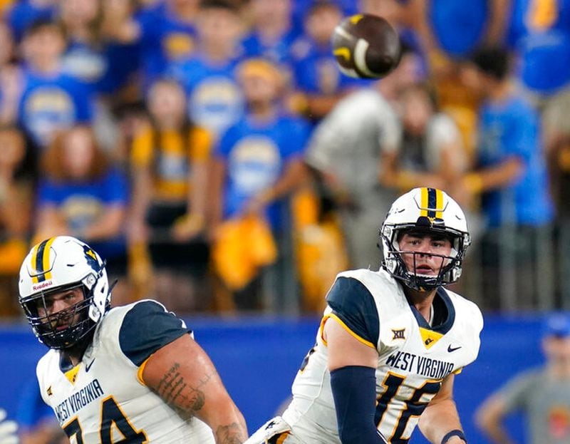 West Virginia quarterback JT Daniels (18) watches a pass against Pittsburgh during the second half of an NCAA college football game Thursday, Sept. 1, 2022, in Pittsburgh. Pittsburgh won 38-31. (AP Photo/Keith Srakocic)