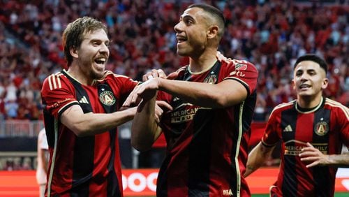 Atlanta United forward Giorgos Giakoumakis (7) signals the crows as he celebrates with midfielder Saba Lobzhanidze (9) after scoring the first goal of his team during the first half against the Chicago Fire at Mercedes-Benz Stadium on Sunday, March 31, 2024.  Miguel Martinez / miguel.martinezjimenez@ajc.com