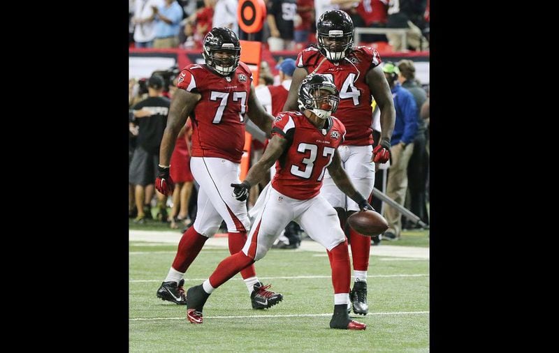 Falcons safety Ricardo Allen (center) celebrates intercepting Eagles quarterback Sam Bradford in the final minutes of the game to hold on to a 26-24 Falcons victory during their Monday Night Football game on Monday, Sept. 14, 2015, in Atlanta. Curtis Compton / ccompton@ajc.com