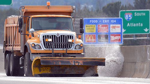 January 29, 2014 Suwanee - A Georgia DOT plow truck scrapes snow and ice on I-85 North near Exit 109 on Wednesday afternoon, January 29, 2014. The Atlanta metro area continues to suffer under the grip of snow and ice covered roads after a mid-day storm paralyzed the area Tuesday. HYOSUB SHIN / HSHIN@AJC.COM See this thing? Atlanta needs about 100 more of them. (Hyosub Shin/AJC)
