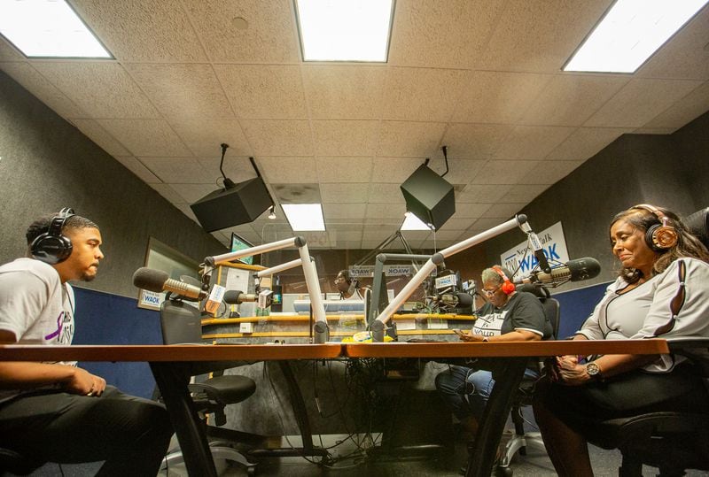 Silas Alexander, left, and Sandra Alexander, right, the son and wife of late radio personality SiMan, are seen in the 1380 WAOK radio studio in Midtown on Monday, Aug. 15, 2022. (Jenni Girtman for The Atlanta Journal-Constitution)