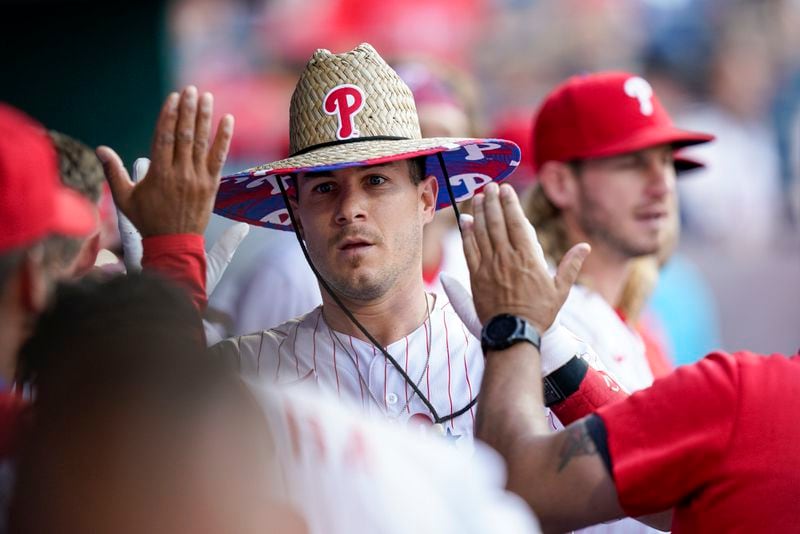 Philadelphia Phillies' J.T. Realmuto celebrates his home run with teammates during the first inning of a baseball game against the Atlanta Braves, Friday, July 23, 2021, in Philadelphia. (AP Photo/Chris Szagola)