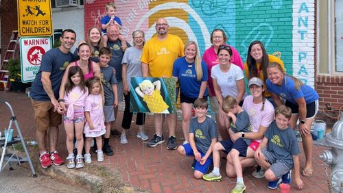 Volunteers painted a mural to support the Mighty Millie Foundation outside of Howdy ATL Cafe in Grant Park.