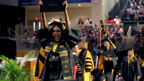 051222 Kennesaw, Ga.: Anaya Banks reacts after receiving her diploma during Kennesaw State University’s Spring 2022 Commencement for the Radow College of Humanities and Social Sciences at the Convocation Center, Thursday, May 12, 2022, in Kennesaw, Ga.. (Jason Getz / Jason.Getz@ajc.com)