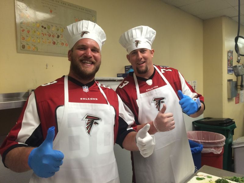Atlanta Falcons players Mike Peterson (left) and Ryan Schraeder during a cook-off at the Georgia Dome the paired the pro players with culinary students.