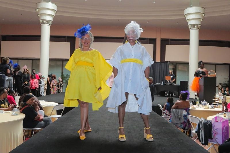 Two ladies smile on the catwalk at 'Seniors on the Runway' on May 4, 2024, at Greenbriar Mall. 