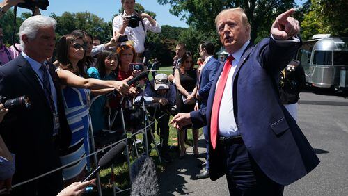 President Donald Trump stops to briefly talk with journalists at the White House on Monday, one day after tweeting that four Democratic congresswomen of color should go back to their own countries. Chip Somodevilla/Getty Images