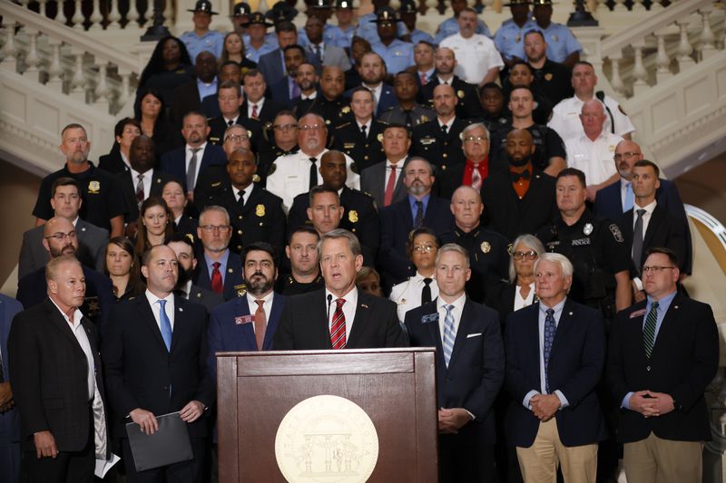 Governor Brian Kemp and Attorney General Chris Carr, alongside state and local law enforcement partners from across the state, on Nov. 3, 2022, announced at a press conference information on major indictments secured as a result of the Gang Prosecution Unit in the Attorney General's Office. Miguel Martinez / miguel.martinezjimenez@ajc.com