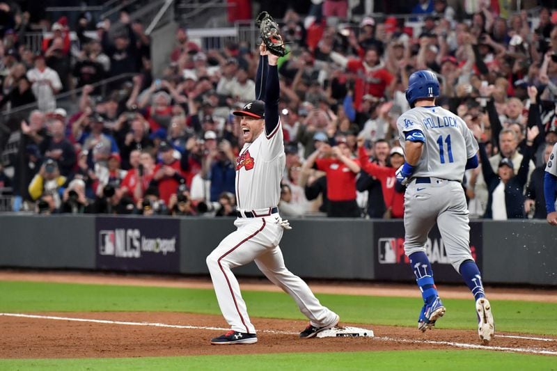 Braves first baseman Freddie Freeman celebrates after collecting the final out of Game 6 of the NLCS and advance to the World Series Saturday, Oct. 23, 2021, at Truist Park in Atlanta. (Hyosub Shin / Hyosub.Shin@ajc.com)