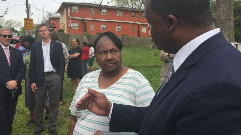 Atlanta Mayor Kasim Reed on Wednesday talks to English Avenue resident Thelma Benton, 72, about a new fund designed to help residents in the community stay in their homes as gentrification lurks.