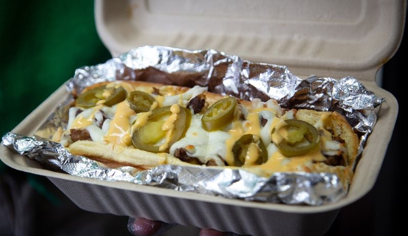 A hot dog topped with cheese and jalapenos is ready to be served at Mason's Super Dogs restaurant in Stonecrest. Steve Schaefer for The Atlanta Journal-Constitution