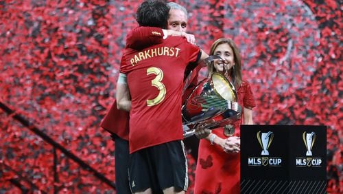 Atlanta United team captain Michael Parkhurst presents owner Arthur Blank the MLS CUP after a 2-0 victory over the Portland Timbers on Saturday, Dec 8, 2018, in Atlanta.   Curtis Compton/ccompton@ajc.com