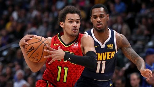 Hawks gaurd Trae Young drives to the basket against the Nuggets' Monte Morris in the first quarter Tuesday, Nov. 15, 2019, at the Pepsi Center in Denver.