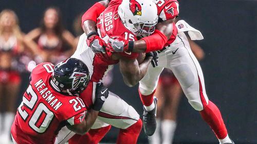 Atlanta Falcons defensive back Sharrod Neasman (20) (left) pulls down Arizona Cardinals wide receiver Jeremy Ross (15) (center) with Atlanta Falcons linebacker Jermaine Grace (56)(right) during 3rd quarter action on Saturday, Aug. 26, 2017 at the opening of the brand new Mercedes Benz Stadium and pre-season NFL game between the Atlanta Falcons and the Arizona Cardinals. JOHN SPINK/JSPINK@AJC.COM