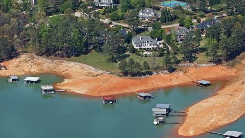 A woman died after falling into Lake Lanier, authorities said.
