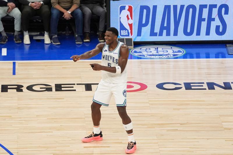 Minnesota Timberwolves guard Anthony Edwards (5) celebrates after a basket made by guard Nickeil Alexander-Walker during the second half of Game 2 of an NBA basketball first-round playoff series against the Phoenix Suns, Tuesday, April 23, 2024, in Minneapolis. (AP Photo/Abbie Parr)