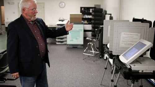 Merle King, executive director for the Center for Election Systems at Kennesaw State University, explains how a DRE, a touchscreen machine voters use when casting their ballot, works, Thursday, Oct. 20, 2016, in Kennesaw, Ga. BRANDEN CAMP/SPECIAL