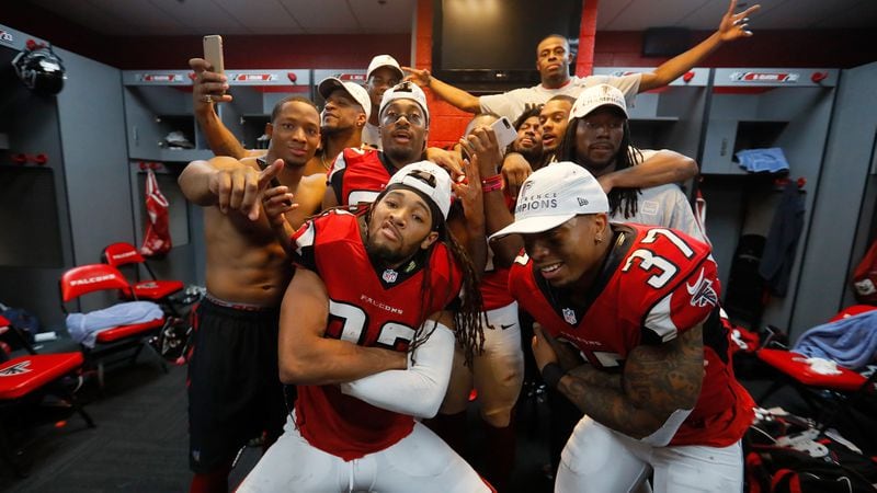  Jalen Collins (32) and Ricardo Allen (37) of the Atlanta Falcons celebrate with teammates in the locker room after defeating the Green Bay Packers in the NFC Championship Game at the Georgia Dome on January 22, 2017 in Atlanta. The Falcons defeated the Packers 44-21. (Kevin C. Cox/Getty Images)