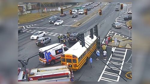 A crash investigation involving a school bus blocked westbound lanes of Ga. 92 in Roswell early Friday, authorities said.