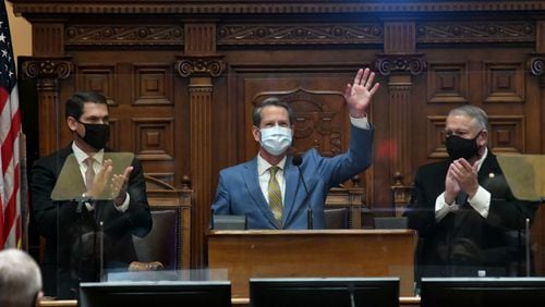 Gov. Brian Kemp, center, Lt. Gov. Geoff Duncan, left, and House Speaker David Ralston wear masks at the governor's State of the State address. The persistence of the coronavirus pandemic threatens to force a suspension of the legislative session for a second straight year. (Hyosub Shin / Hyosub.Shin@ajc.com)