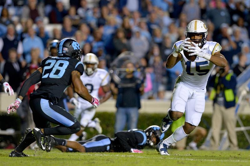 CHAPEL HILL, NC - OCTOBER 18: DeAndre Smelter #15 of the Georgia Tech Yellow Jackets makes a catch against Brian Walker #28 of the North Carolina Tar Heels and runs it in for a touchdown during the third quarter of their game at Kenan Stadium on October 18, 2014 in Chapel Hill, North Carolina. North Carolina won 48-43. (Photo by Grant Halverson/Getty Images)