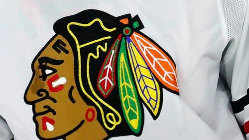 FILE - The Chicago Blackhawks logo adorns a jersey in Raleigh, N.C., May 3, 2021. A consultant the Chicago Blackhawks hired to improve relationships with American Indian tribes filed a lawsuit Tuesday, May 14, 2024, accusing the team, its charity foundation and its CEO of fraud, breach of contract and sexual harassment. (AP Photo/Karl B DeBlaker, File)