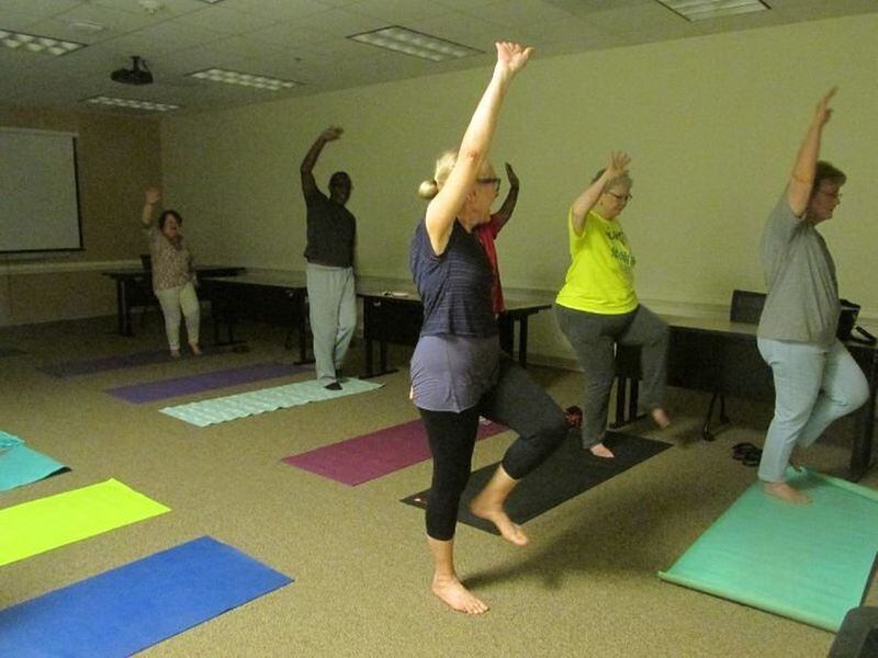 Seniors participate in a yoga class at the Cobb Wellness Center in Marietta. Beginning in February, Cobb seniors will be required to purchase an annual membership to use the senior centers. Certain classes, activities and trips will be charged additional fees.