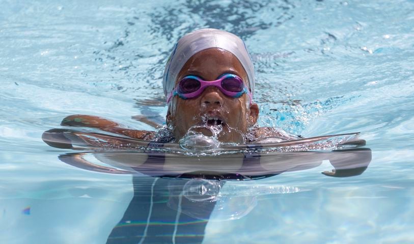 Sanaya McClendon, 8, competes in the breast stroke in a swim meet at Leslie Beach Club in Atlanta on Saturday, May 21, 2022.    According to the USA Swimming Foundation, while most Americans learn how to swim during childhood, 64% of Black children in America have little to no swimming ability. (Bob Andres / robert.andres@ajc.com)