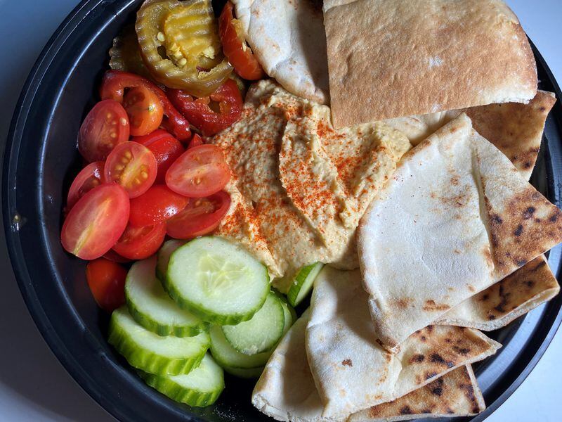 Stats Brewpub's lemon and herb hummus is served with pickled cherry peppers and warm pita bread. Bob Townsend for The AJC