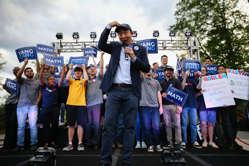 2020 Democratic presidential candidate Andrew Yang points to his "MATH" hat at a campaign event in Piedmont Park. ELIJAH NOUVELAGE/SPECIAL