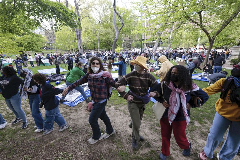 People lock arms during a Pro-Palestinian protest on Penn's campus in Philadelphia on Thursday, April 25, 2024. (Elizabeth Robertson/The Philadelphia Inquirer via AP)
