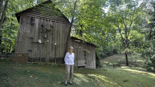 Wylene Tritt, 84, poses for a portrait behind her family’s barn in Marietta, Georgia, on Monday, October 3, 2016. The barn was built by Tritt’s father-in-law, Will Tritt in the 1940’s. (DAVID BARNES / DAVID.BARNES@AJC.COM)