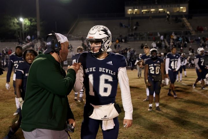 Dec. 18, 2020 - Norcross, Ga: A Grayson assistant coach, left, greets Norcross quarterback Mason Kaplan (16) after NorcrossÕ loss to Grayson in the Class AAAAAAA semi-final game at Norcross high school Friday, December 18, 2020 in Norcross, Ga.. Grayson won 28-0 to advance to the Class AAAAAAA finals. JASON GETZ FOR THE ATLANTA JOURNAL-CONSTITUTION