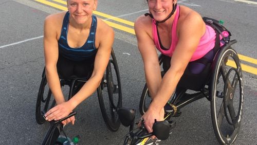 Susannah Scaroni, winner of the 2018 AJC Peachtree Road Race wheelchair division, poses with friend and runner-up Tatyana McFadden. (Gabe Burns/AJC)