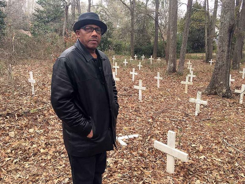 Waymond Mundy in an African American cemetery in Monroe where Mae Murray Dorsey, one of the Moore’s Ford lynching victims, is buried. Many of the graves were unmarked and marred by development when Mundy and others in the Moore’s Ford Memorial Committee marked the graves with white crosses. The group helped install a headstone to recognize Dorsey.