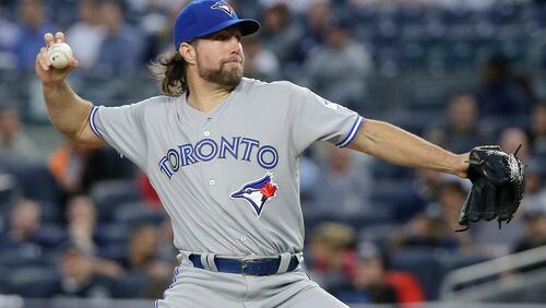 FILE - In this May 24, 2016, file photo, then-Toronto Blue Jays pitcher R.A. Dickey delivers against the New York Yankees during the first inning of a baseball game in New York. Former NL Cy Young Award winner R.A. Dickey and the Atlanta Braves have agreed to a one-year contract, adding a 42-year-old knuckleballer to a thin rotation as the team moves into a new ballpark. Dickey’s agreement, announced Thursday, Nov. 10, 2016, is subject to a successful physical. (AP Photo/Julie Jacobson, File)