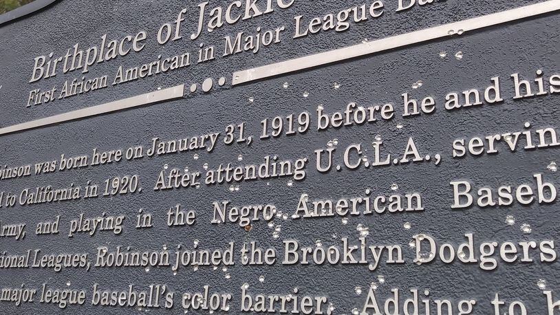 The historical marker recognizing the birthplace of African American baseball great Jackie Robinson was found riddled by gunfire the week of February 14, 2021 in Grady County, Ga. The defacement was one of at least two incidents in the past six months of vandalism to significant markers dedicated to the legacy of Black Georgians. Officials say the fact firearms were used is significant.