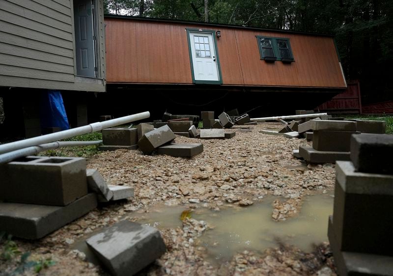 Dorothy and Earl Blevins' temporary home sits off its foundation after it was moved by flooded water and into the new home they are building on property once owned by Dorothy's mother on Sunday, May 5, 2024, in Spendora, Texas. "We've never flooded like this," said Dorothy. (Elizabeth Conley/Houston Chronicle via AP)