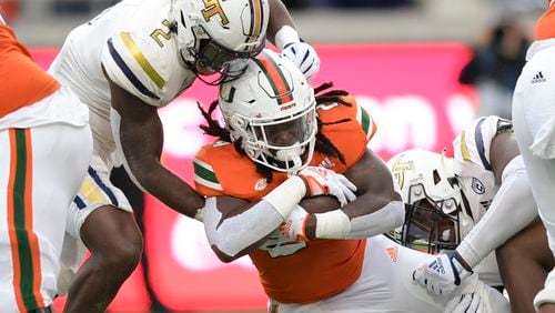 Georgia Tech Yellow Jackets linebacker Ayinde Eley (2) makes a tackle on Miami Hurricanes safety Kamren Kinchens (24) in the first half of play Saturday, Nov. 12, 2022 at Bobby Dodd Stadium. (Daniel Varnado/For the AJC)