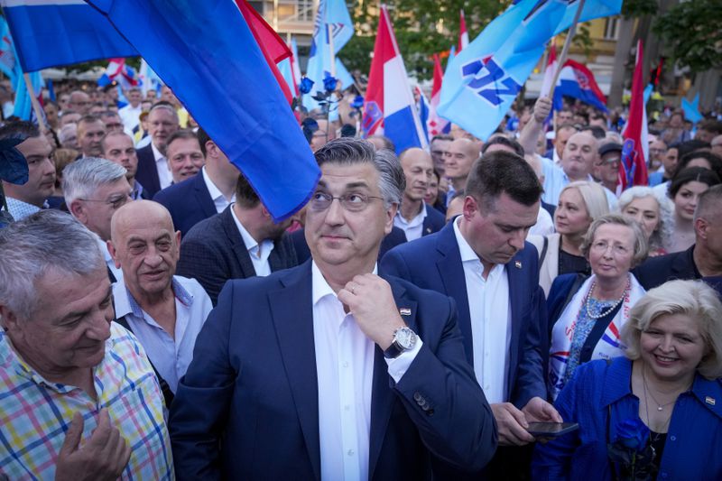 Prime Minister incumbent Andrej Plenkovic, centre, attends his party's rally in Zagreb, Croatia, Sunday, April 14, 2024. Croatia this week holds an early parliamentary election following a campaign that was marked by heated exchanges between the country's two top officials, creating a political crisis in the Balkan country, a European Union and NATO member state. (AP Photo/Darko Bandic)