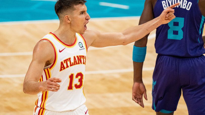 Bogdan Bogdanovic (13) of the Atlanta Hawks reacts to a call against the Charlotte Hornets in the fourth quarter during their game at Spectrum Center on April 11, 2021 in Charlotte, North Carolina. (Jacob Kupferman/Getty Images/TNS)