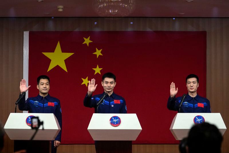 Chinese astronauts for the upcoming Shenzhou-18 mission, from left, Li Guangsu, Ye Guangfu and Li Cong wave as they arrive for a meeting with the press at the Jiuquan Satellite Launch Center in northwest China, Wednesday, April 24, 2024. (AP Photo/Andy Wong)